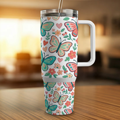 Tumbler with butterflies and flowers pattern, white handle.