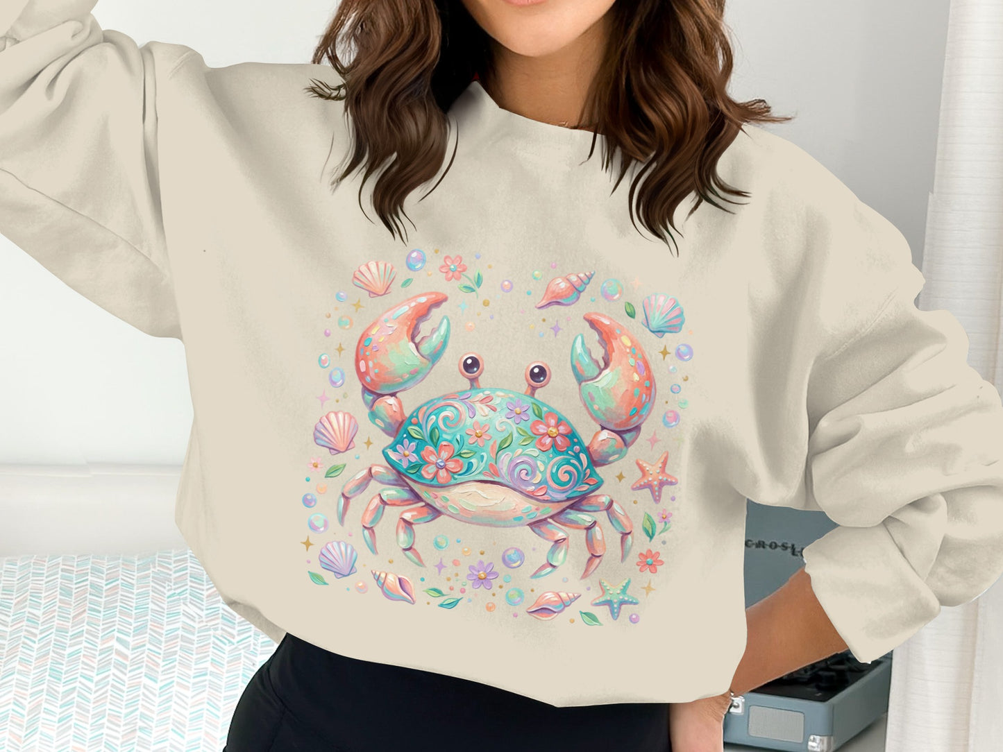 Crewneck sweatshirt with a colorful floral crab design and scattered seashells.