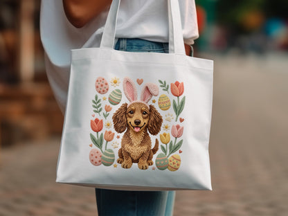Tote bag with a dachshund wearing bunny ears surrounded by Easter eggs and tulips.