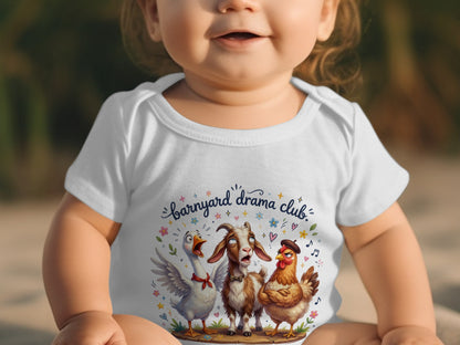 Baby wearing white bodysuit with "Barnyard Drama Club" design of duck, goat, and chicken.
