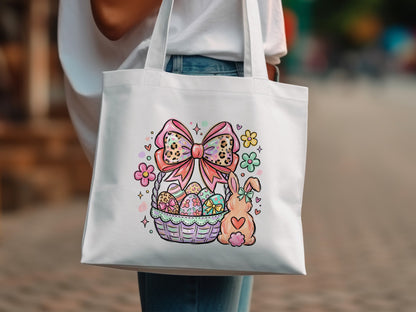 White tote bag with Easter basket, bunny, and flowers graphic.