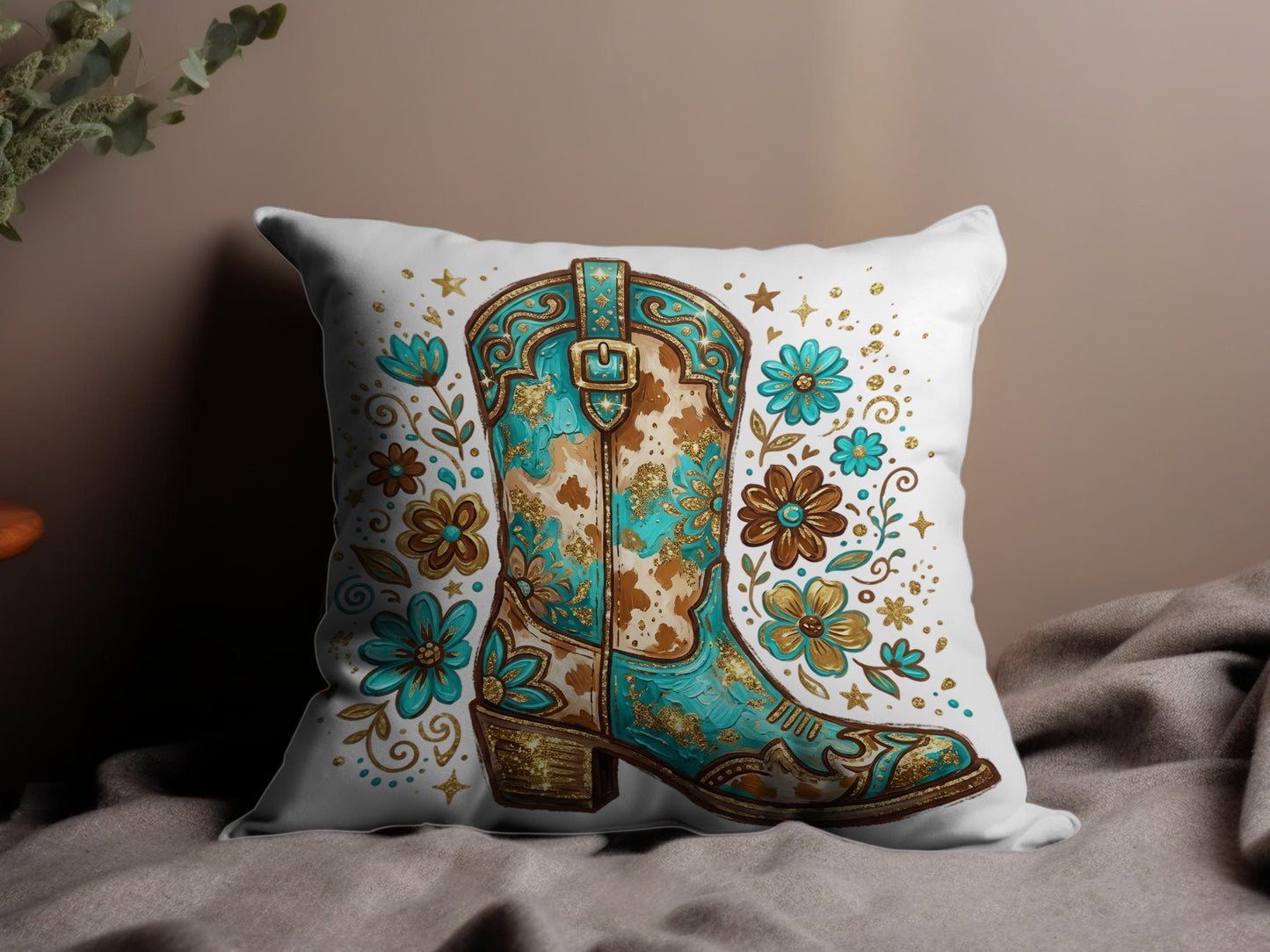 Turquoise cowboy boot with floral accents on a decorative pillow.