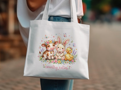 White tote bag with watercolor cow, bunny, and chick surrounded by flowers.