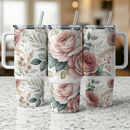 Three floral tumblers with pink roses and green leaves on a granite countertop.