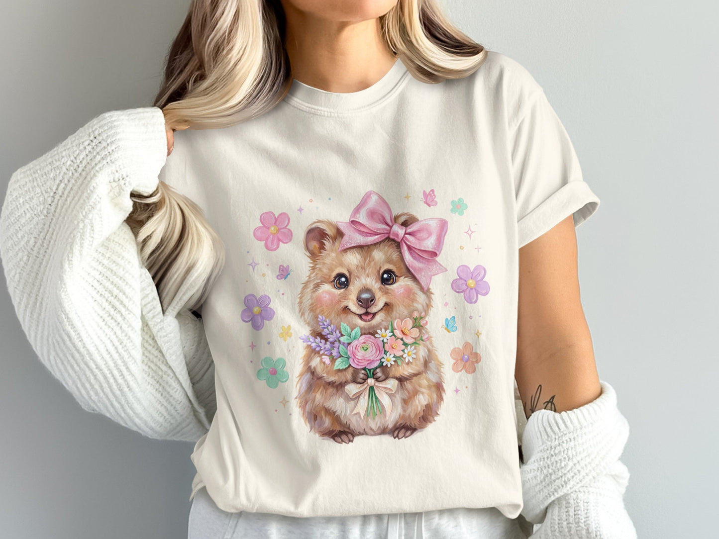 Cute quokka holding a bouquet of flowers with a pink bow.