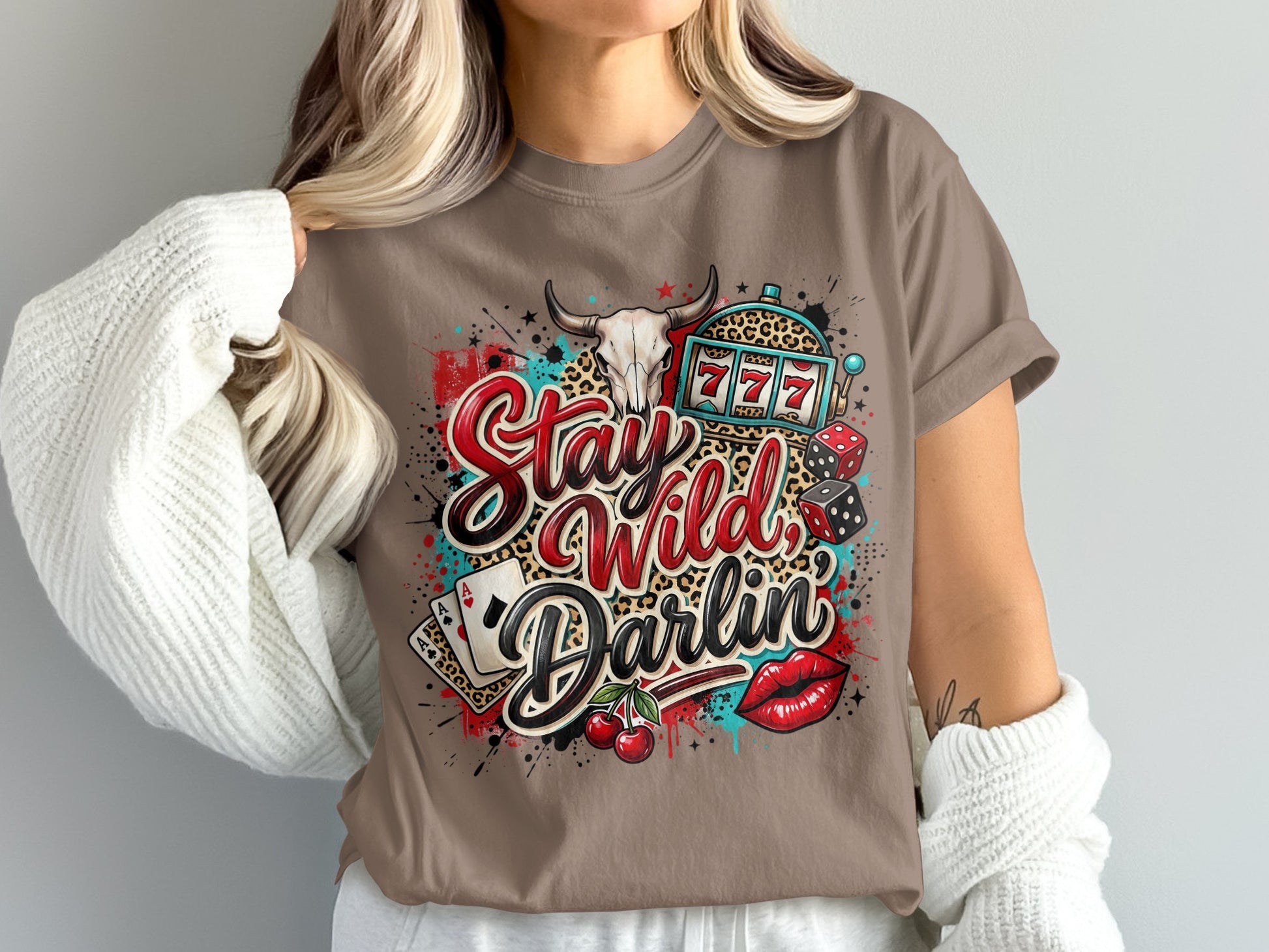 Brown t-shirt with "Stay Wild Darlin'" text, skull, dice, and cherries.