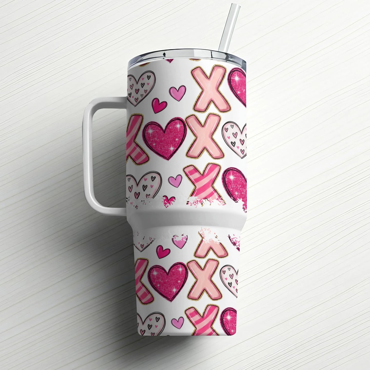Tumbler with XOXO and heart pattern.