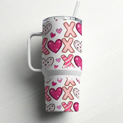 Tumbler with XOXO and heart pattern.