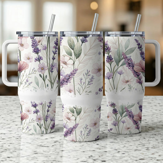 Three floral patterned tumblers with straws, on a speckled surface.