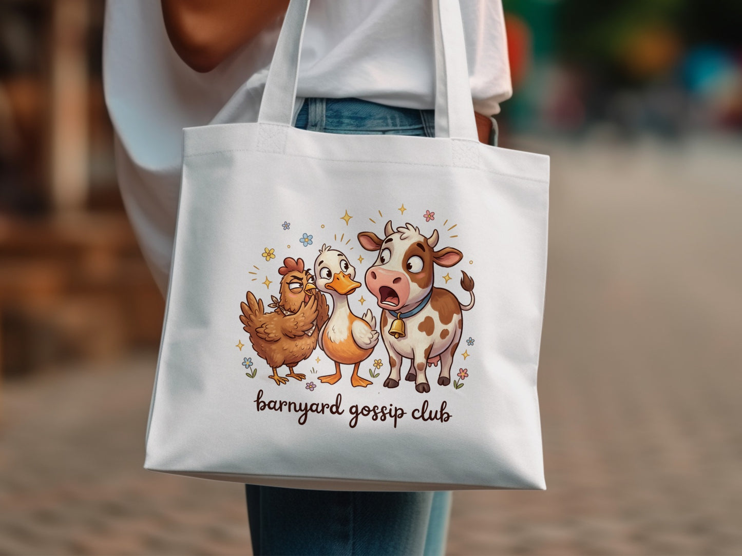 White tote bag with "Barnyard Gossip Club" text and cartoon chicken, duck, and cow.