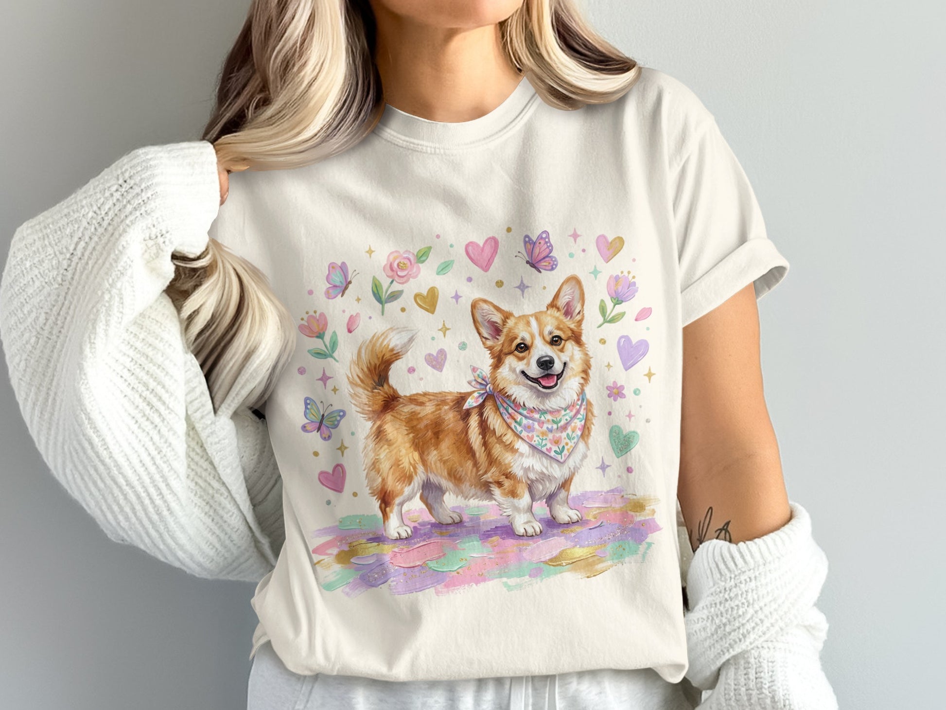 Cream t-shirt with a watercolor corgi wearing a bandana, surrounded by hearts and butterflies.