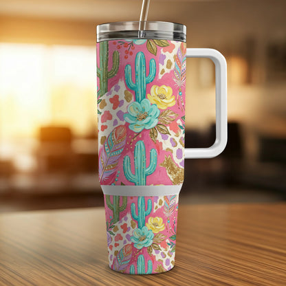 Pink tumbler with cactus, feather, and floral pattern.