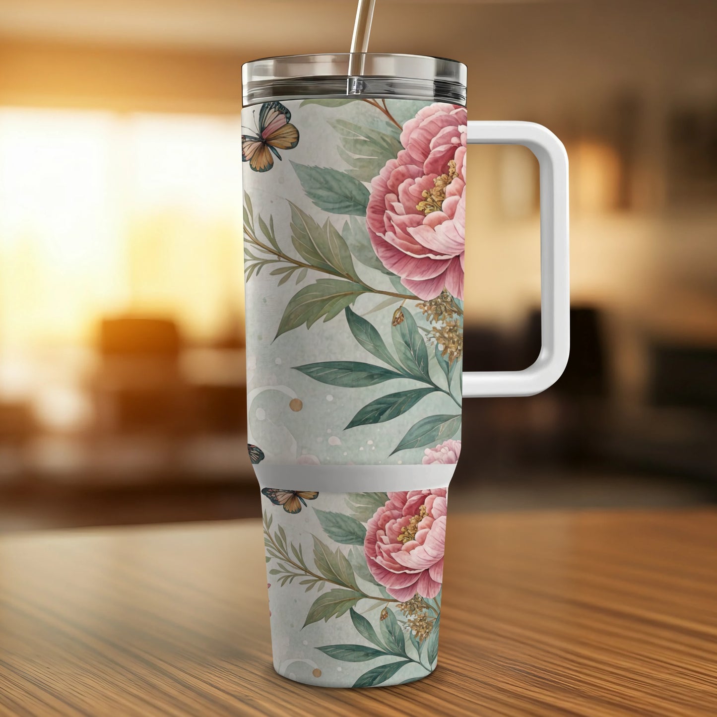 Floral tumbler with pink peonies and butterflies, featuring a white handle.