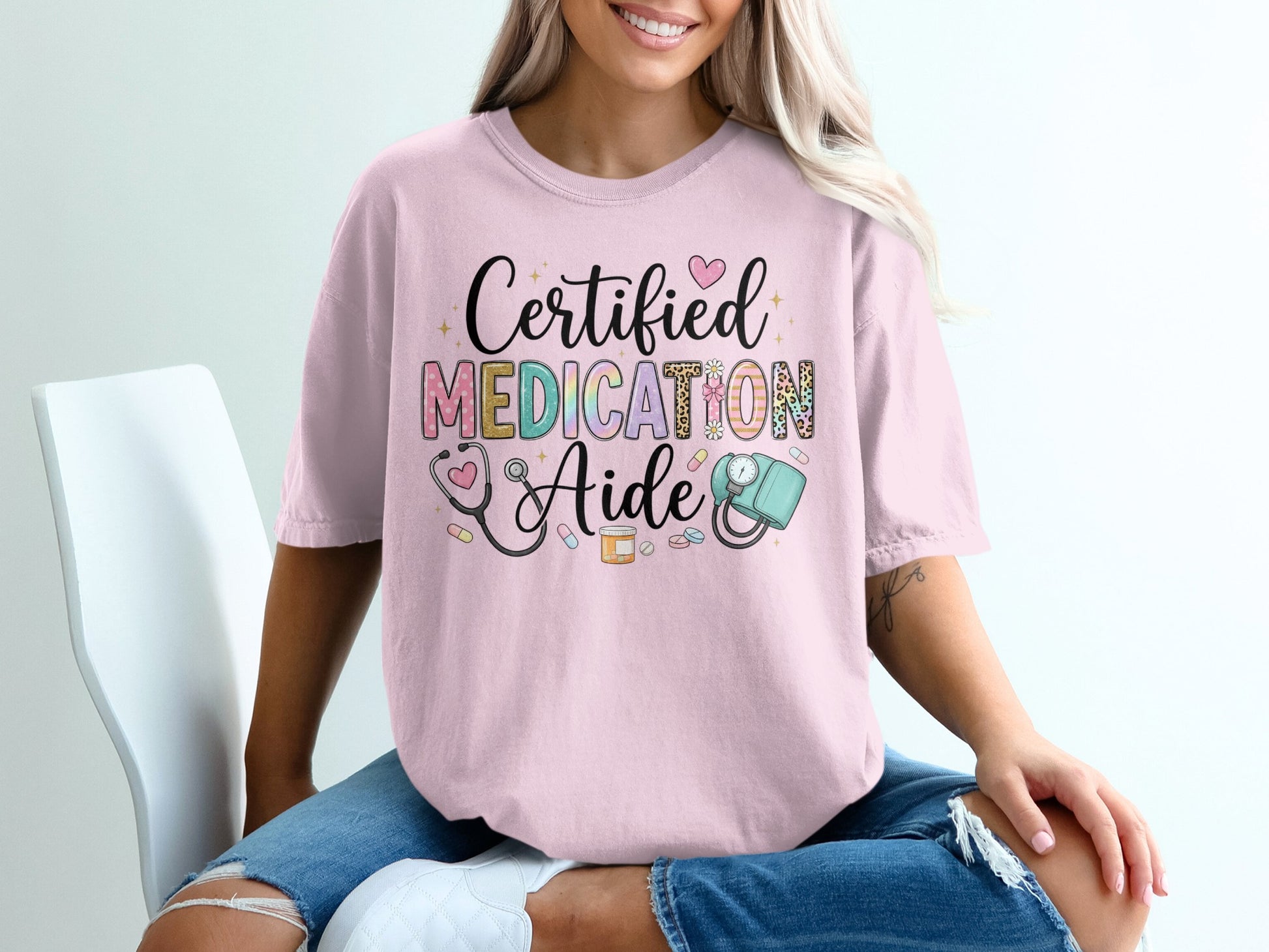 Certified Medication Aide graphic on a pink t-shirt with medical icons.