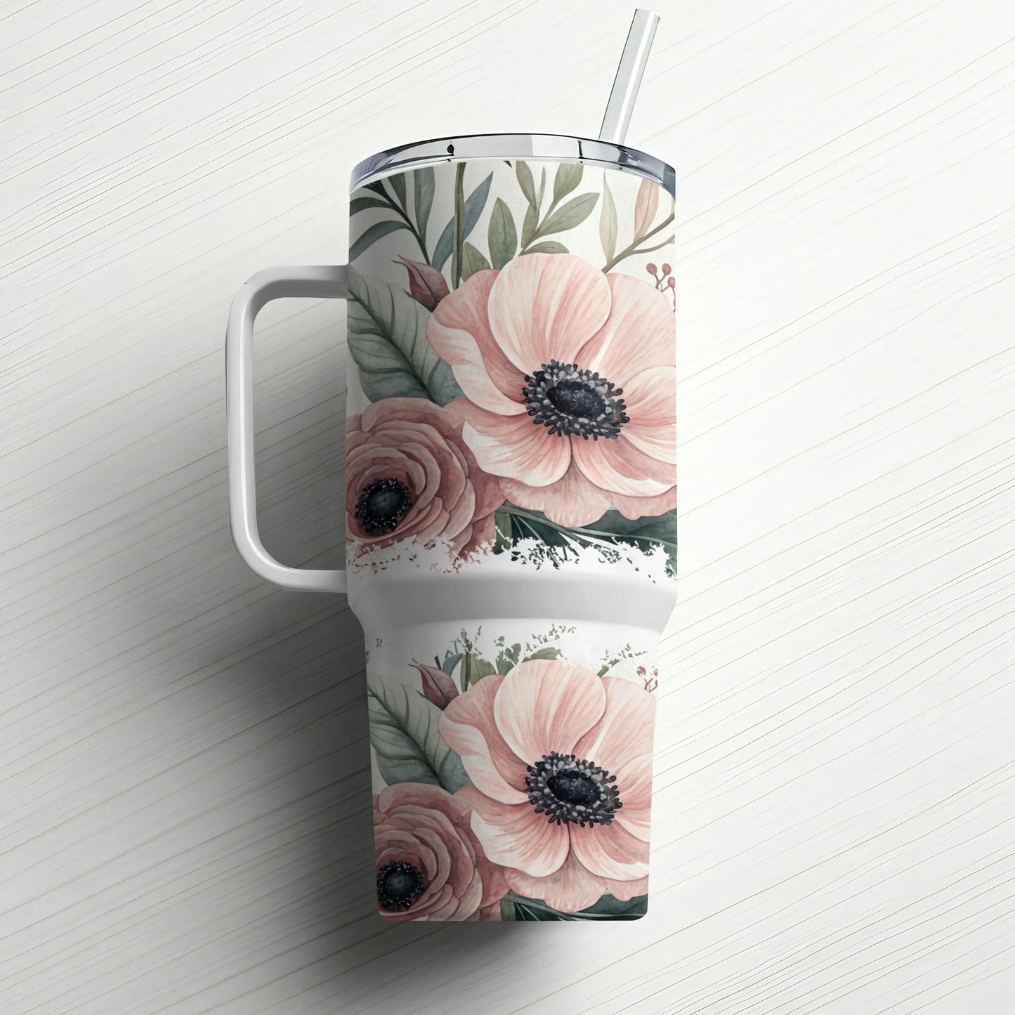Pink floral pattern on a white tumbler with handle and straw.