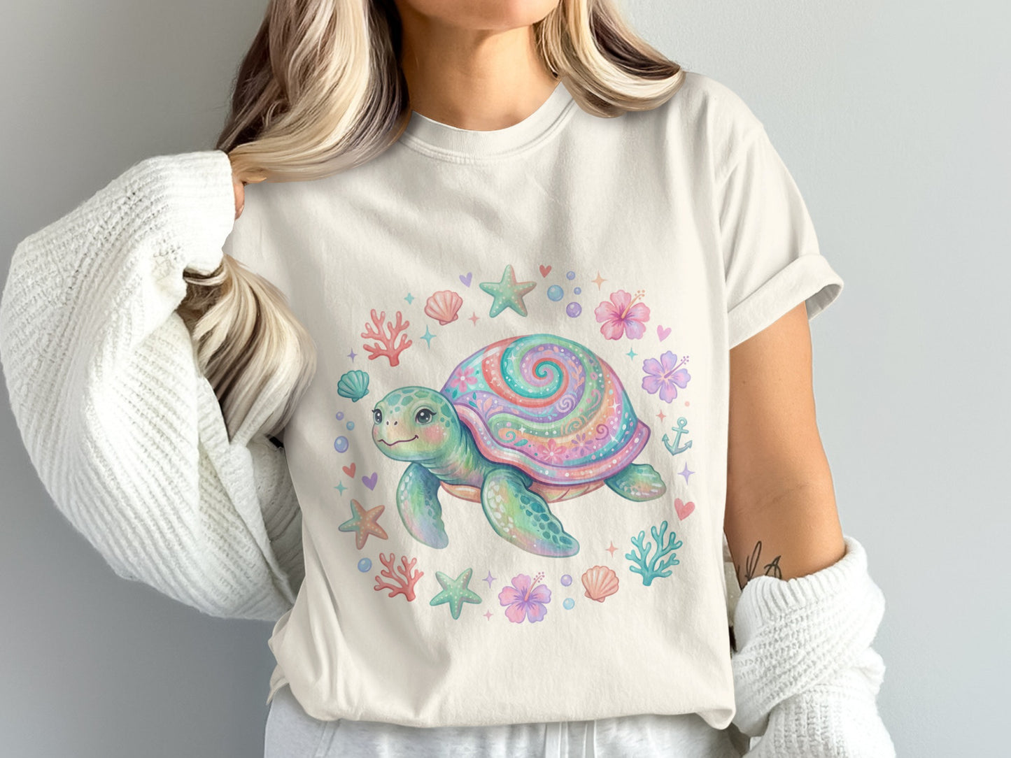 T-shirt featuring a colorful watercolor sea turtle surrounded by seashells and starfish.