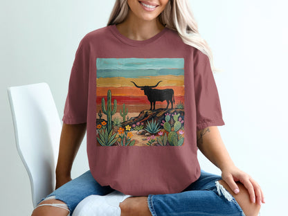 T-shirt with a desert landscape and longhorn cattle graphic.