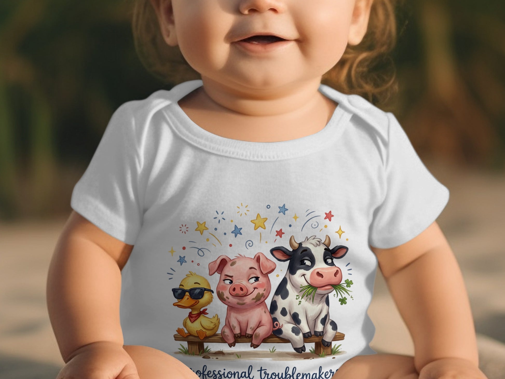 Baby wearing white bodysuit with cartoon pig, cow, and duck on a bench.