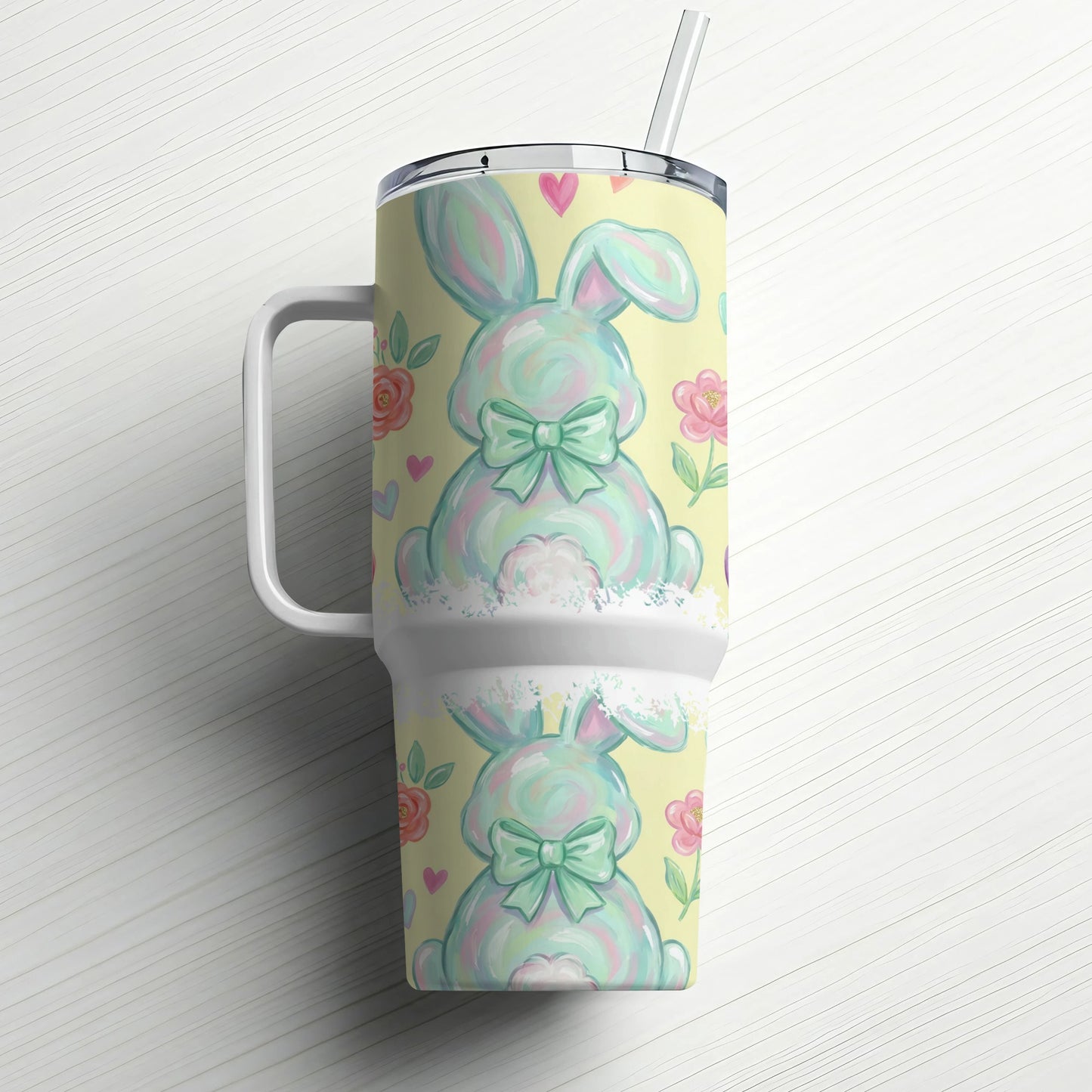 Pastel bunny with bows and flowers on a tumbler with straw.