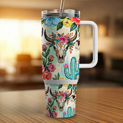 Cow skull and cactus floral pattern on a travel tumbler with handle.