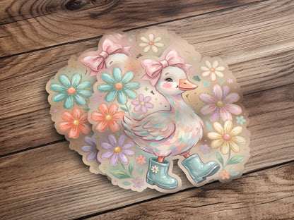 Cute cartoon duck wearing boots, surrounded by flowers and bows.