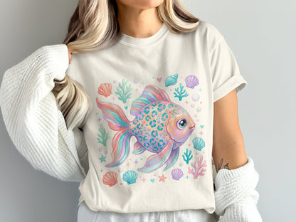 Colorful fish with leopard spots surrounded by seashells and coral on a t-shirt.