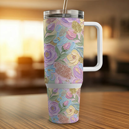 Floral patterned tumbler with handle and straw on a wooden surface.