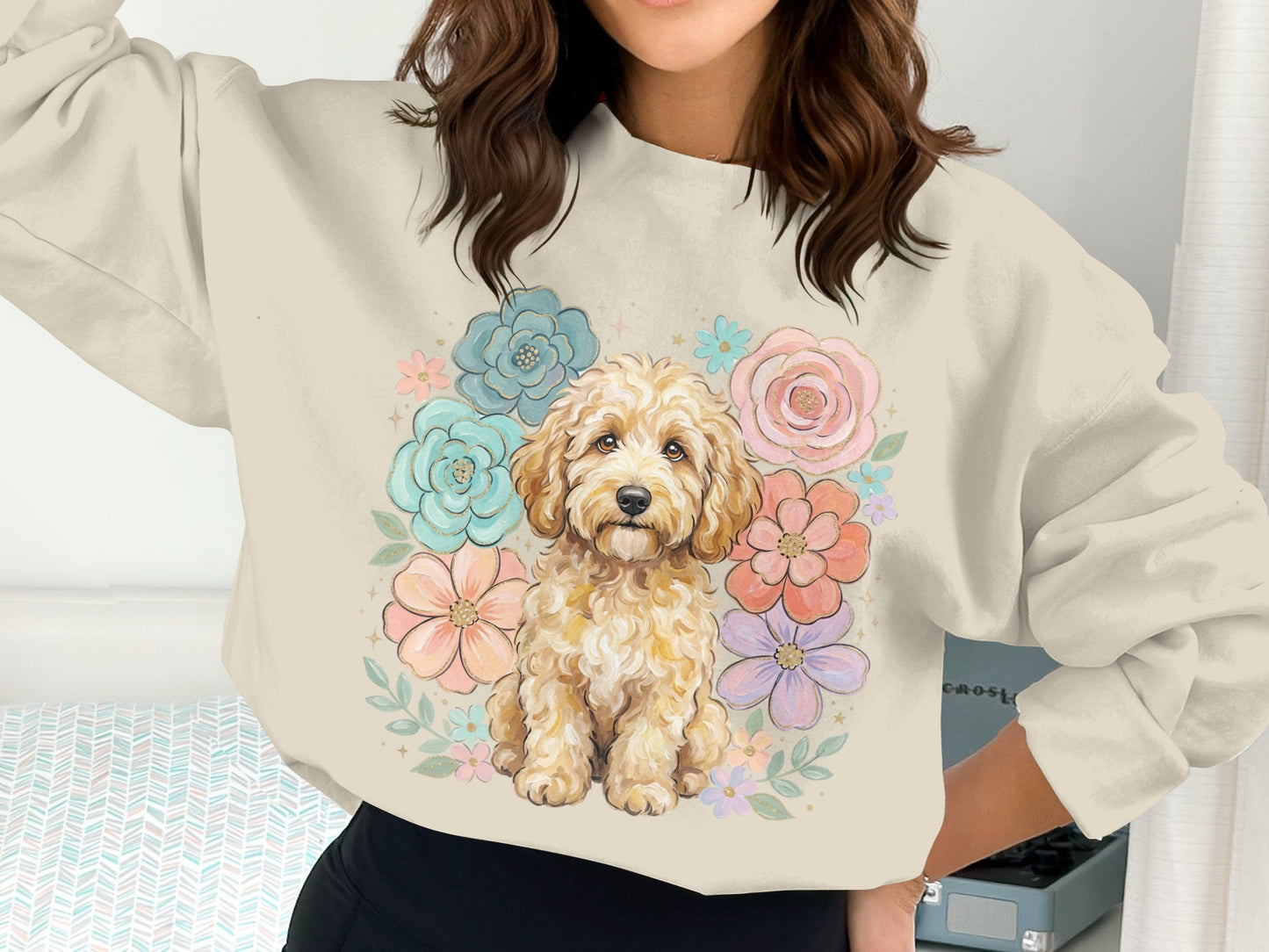 Creamy gold doodle dog sits amidst pastel watercolor flowers on a cream sweatshirt.