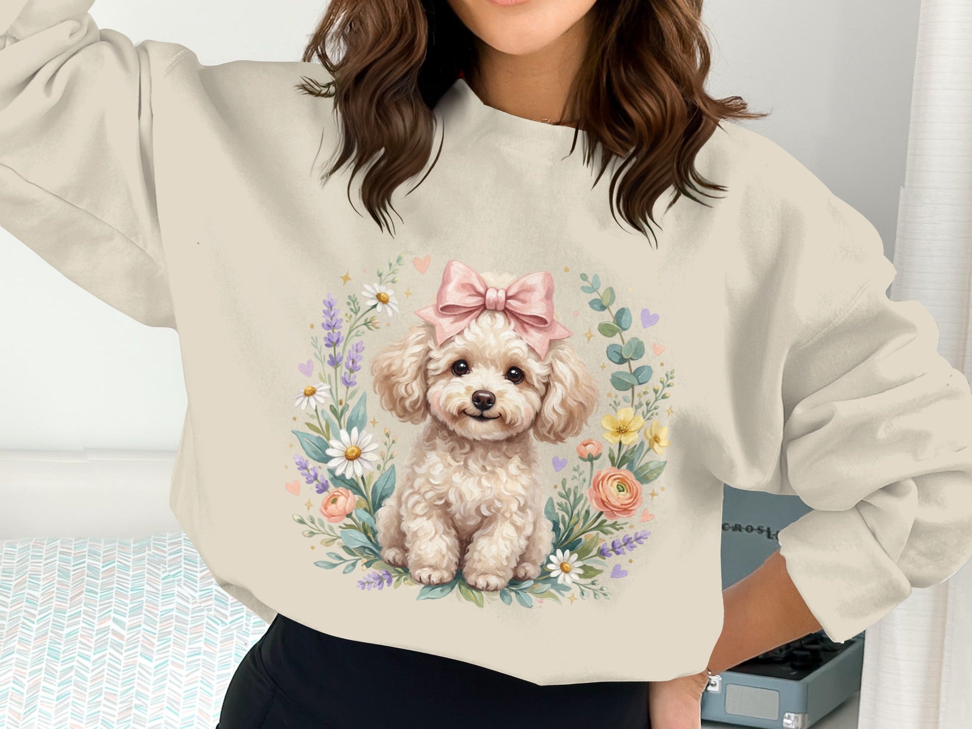 Cream sweatshirt with a fluffy white poodle wearing a pink bow surrounded by flowers.