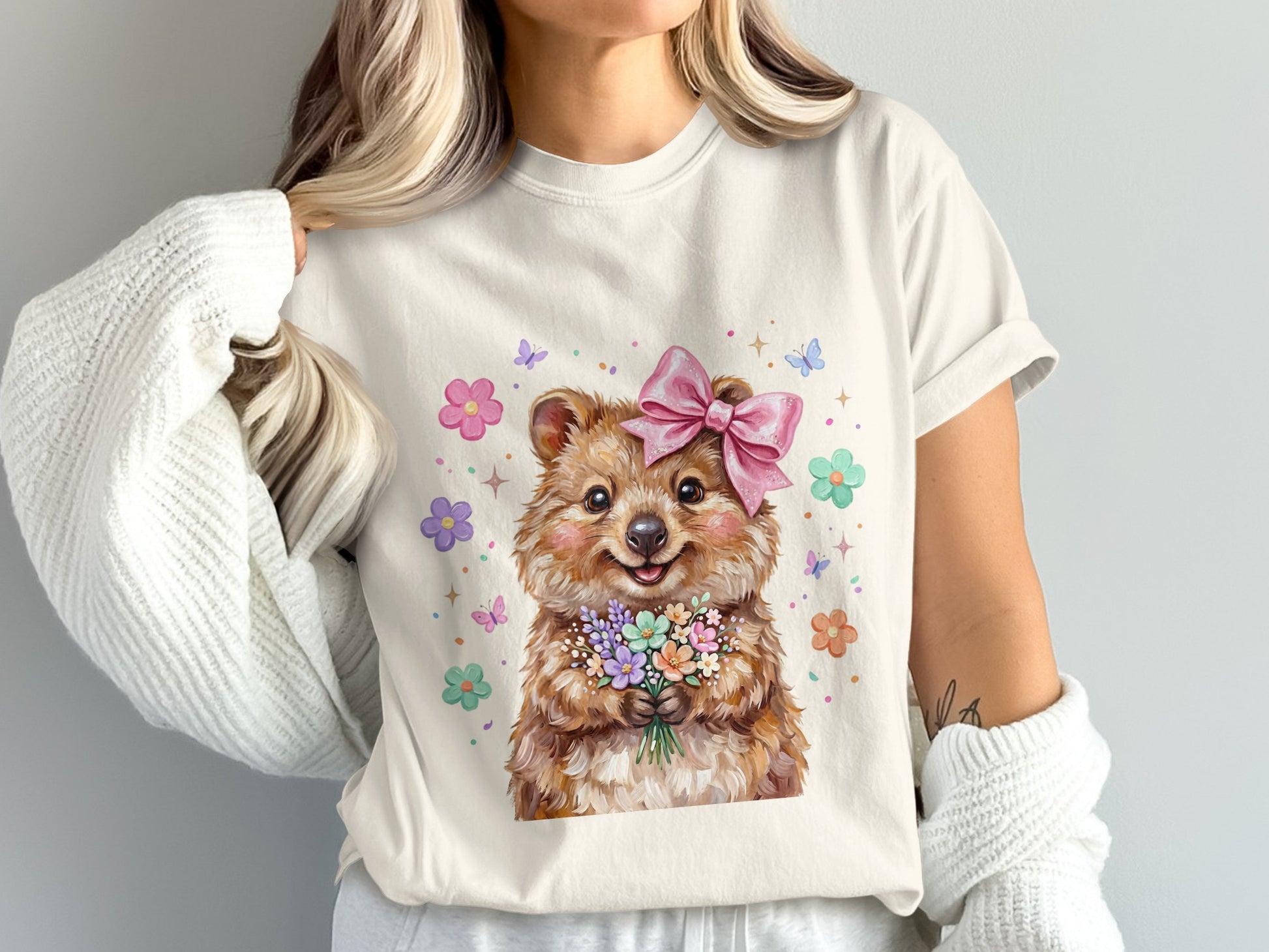 Quokka wearing a pink bow holding a bouquet of flowers, surrounded by butterflies.