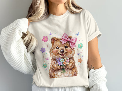 Quokka wearing a pink bow holding a bouquet of flowers, surrounded by butterflies.