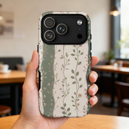 iPhone 14 Pro case with a floral botanical pattern on a neutral background.