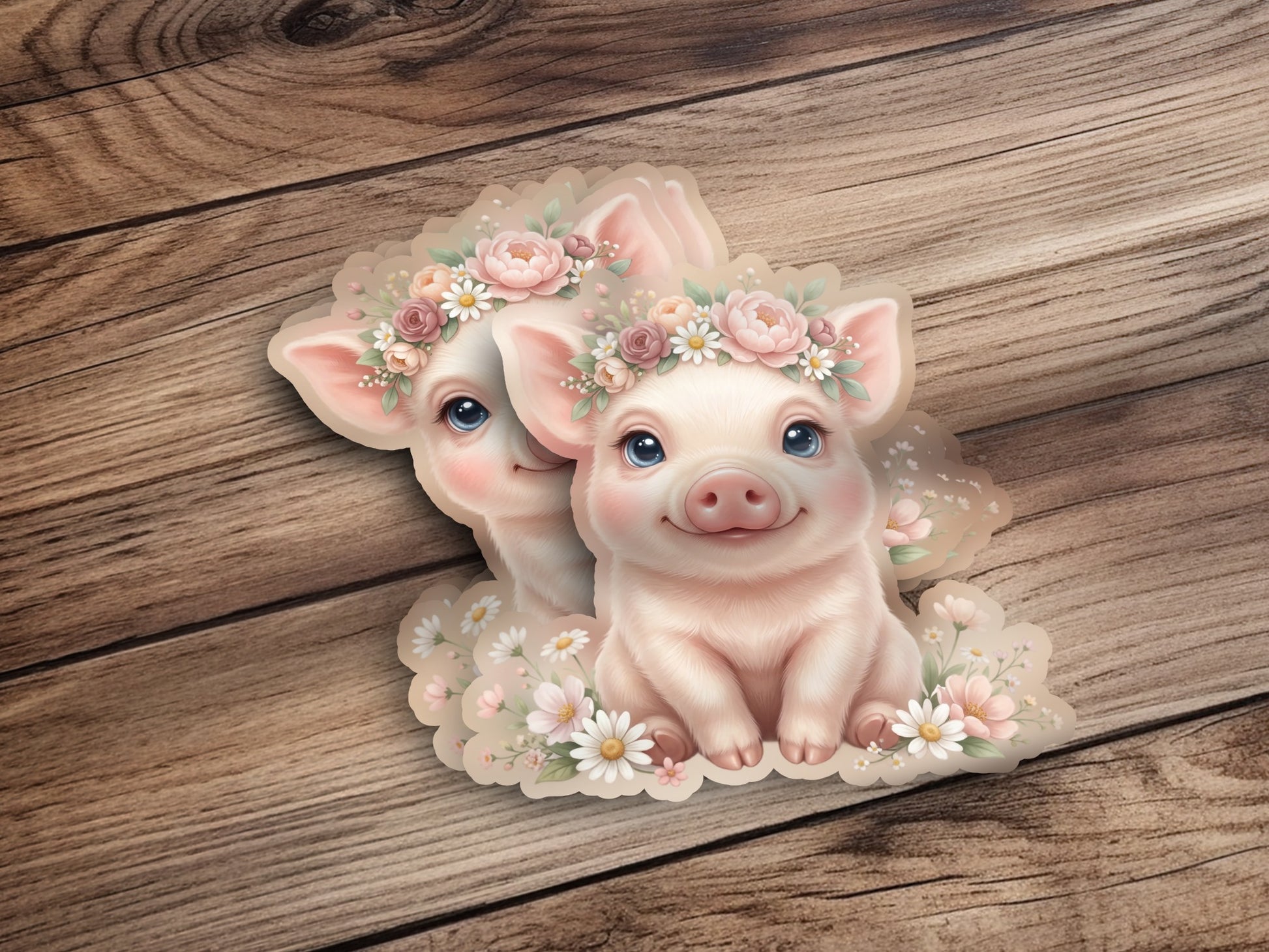 Two cute pigs wearing floral crowns, nestled among flowers on a wooden background.