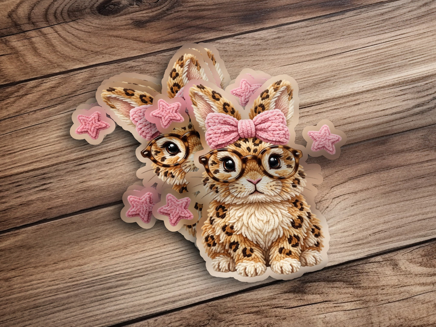 Cute leopard print bunny with glasses and pink bow, surrounded by stars.