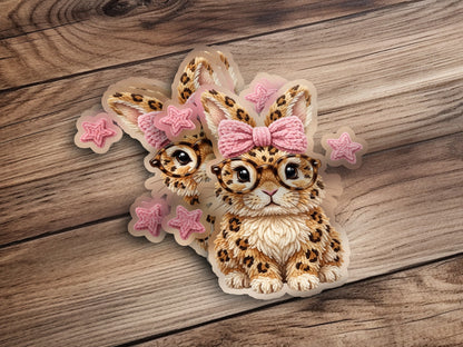 Cute leopard print bunny with glasses and pink bow, surrounded by stars.