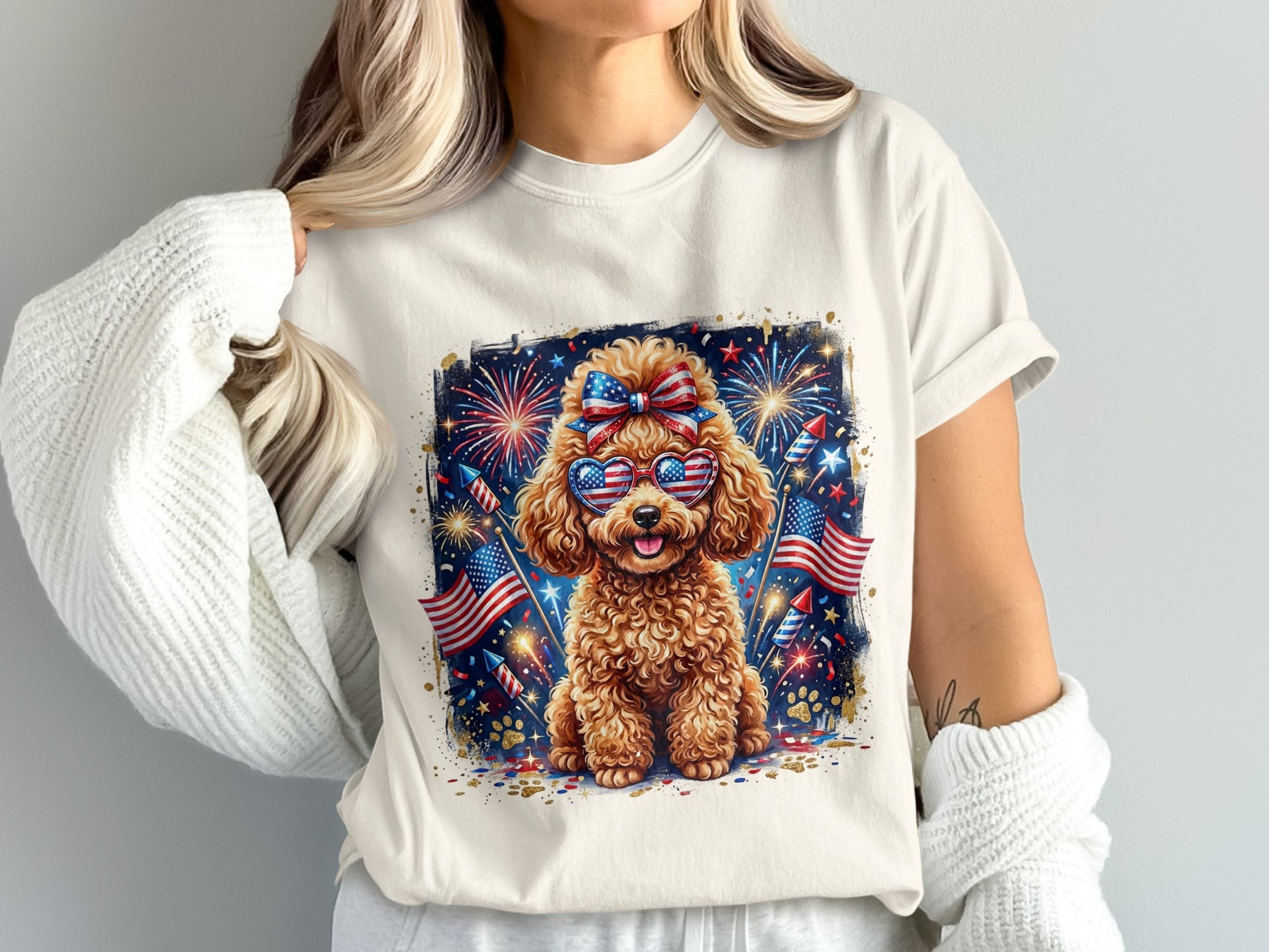 Poodle wearing sunglasses and a headband with fireworks and American flags.