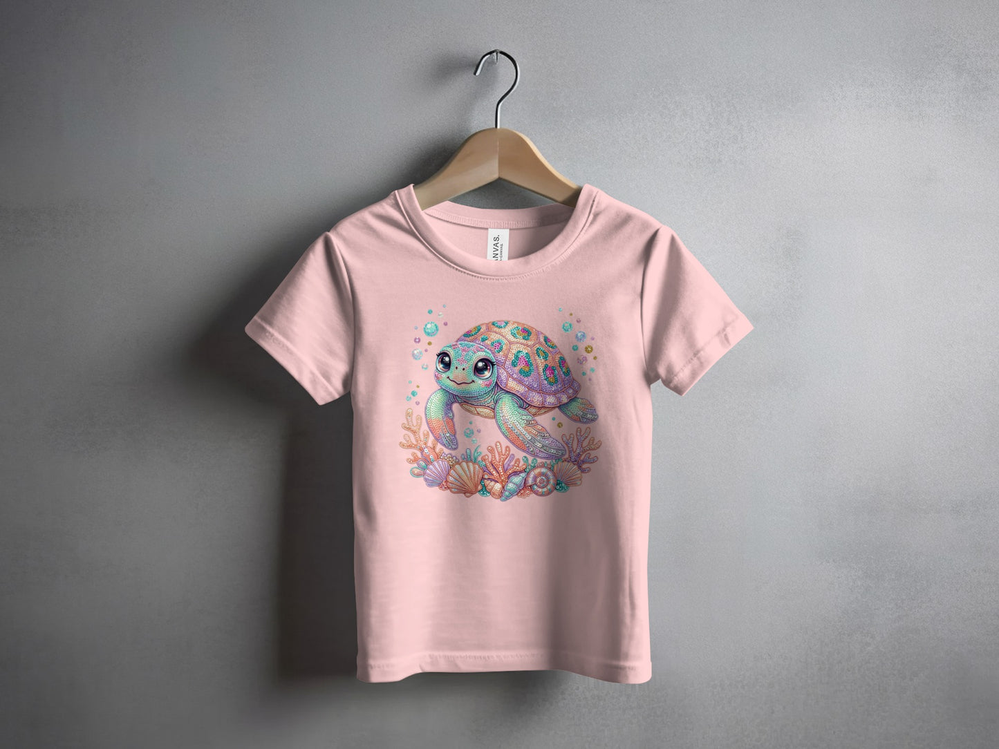 Pink t-shirt with a cartoon sea turtle and colorful seashells design.