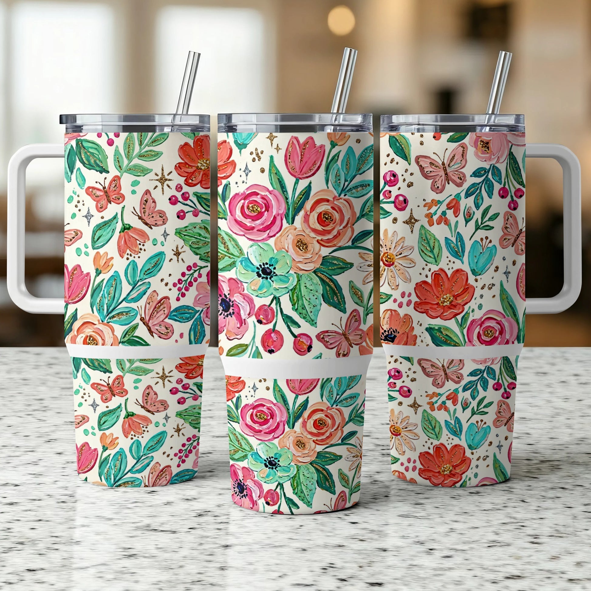 Three tumblers with floral butterfly design, stainless steel lids, and straws.