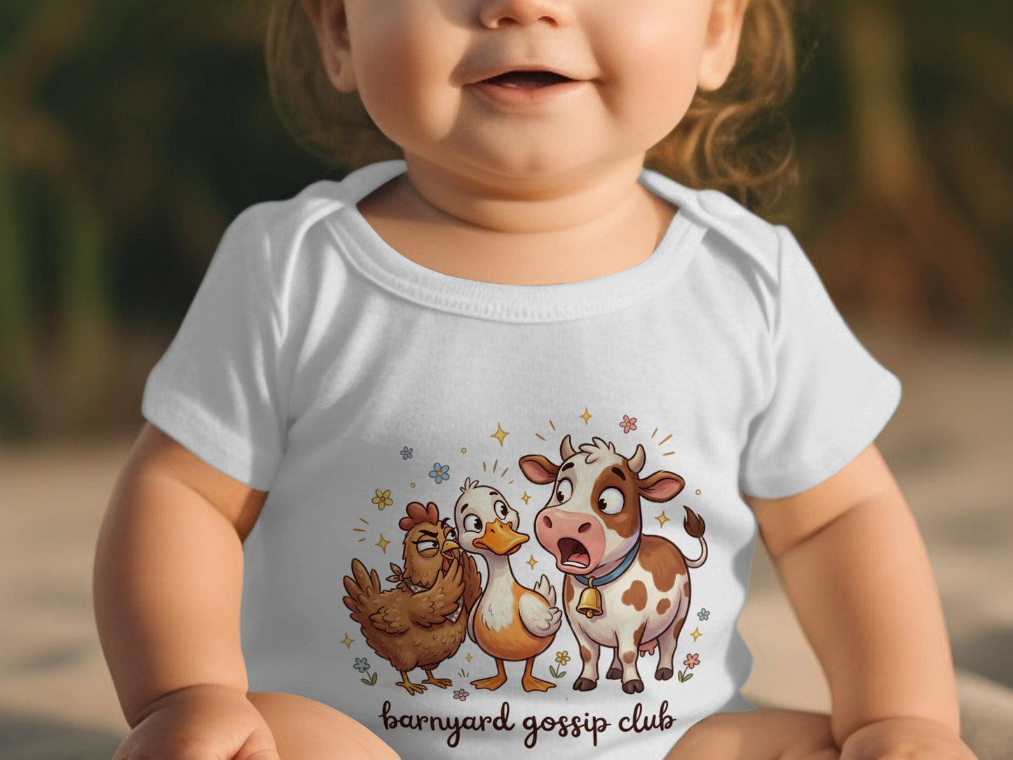 Baby wearing a white bodysuit with cartoon cow, chicken, and duck saying "Barnyard gossip club."