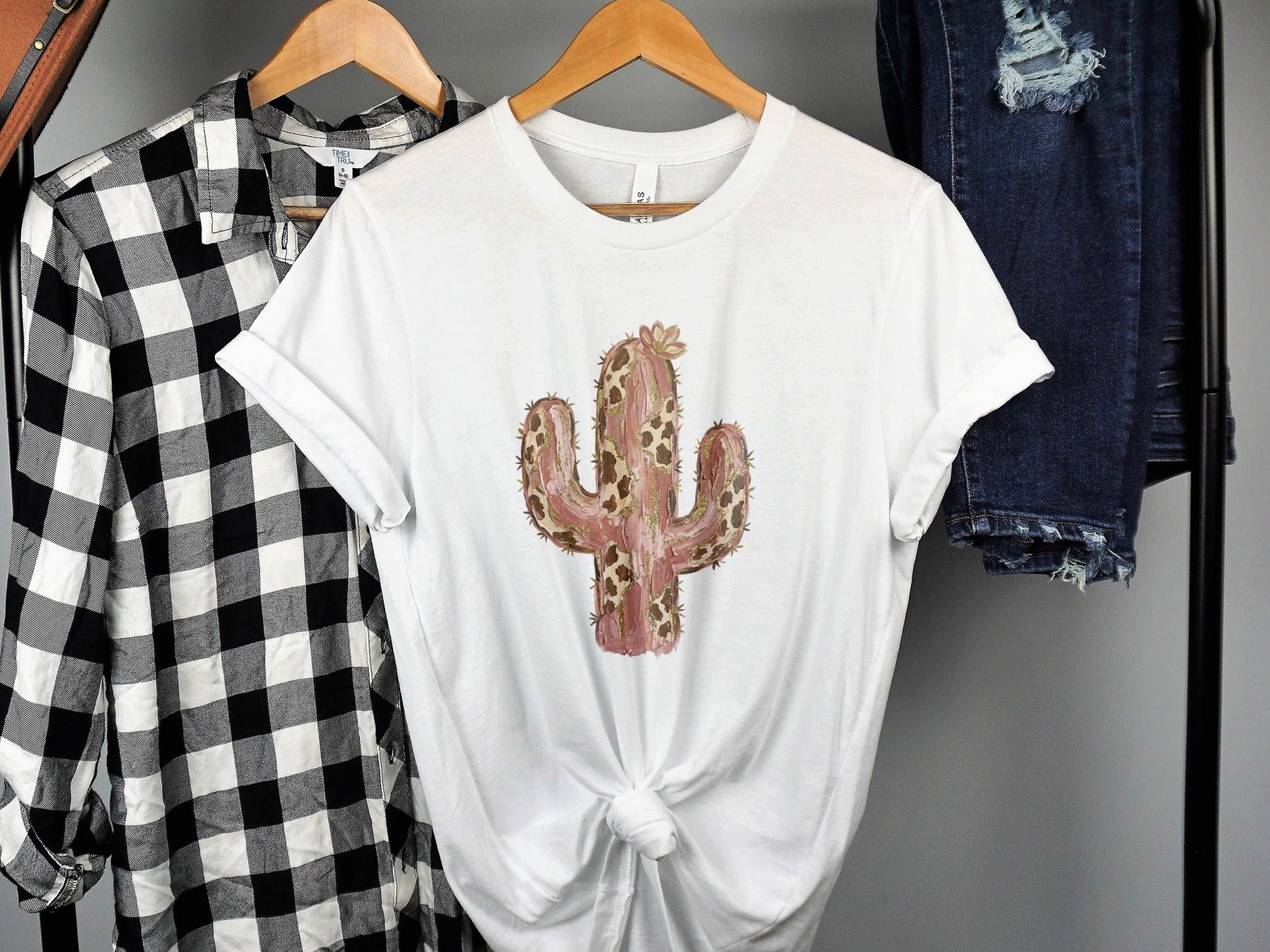 White t-shirt with a pink and brown patterned cactus graphic.