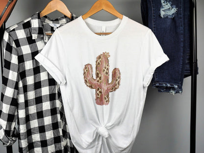White t-shirt with a pink and brown patterned cactus graphic.