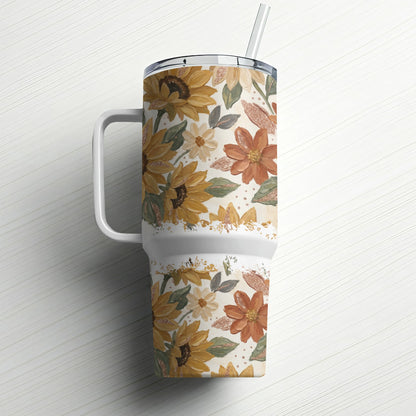 Sunflower and floral patterned tumbler with straw on white background.