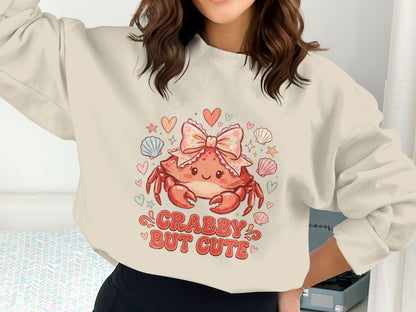 Crabby but cute crab graphic with shells and hearts on a light sweatshirt.