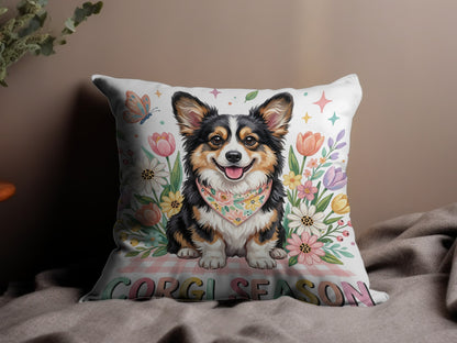 Smiling corgi with bandana on pillow surrounded by flowers and "CORGI SEASON" text.