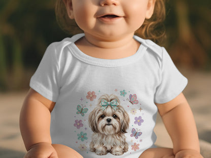 Baby in white onesie with a Shih Tzu and flowers graphic.
