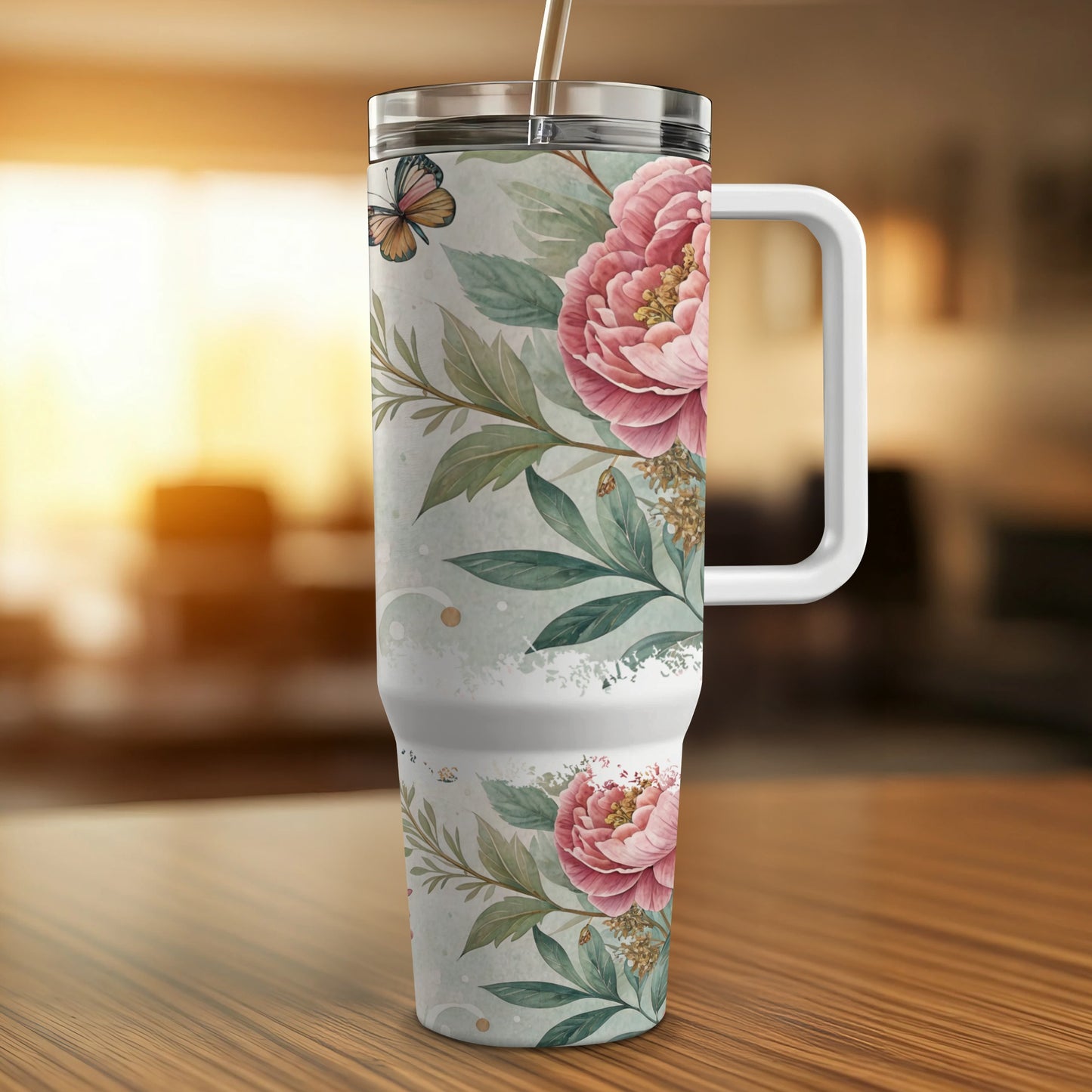 White tumbler with pink peonies and a butterfly on a wooden surface.