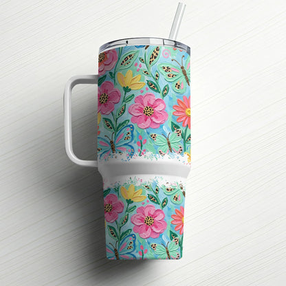 White tumbler with colorful floral and butterfly pattern, featuring a straw.