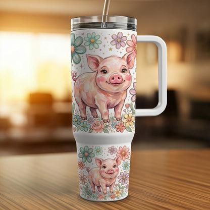 Pink pig illustration on a floral patterned tumbler with handle.