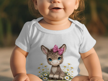 Baby wearing white onesie with smiling donkey and pink bow graphic.