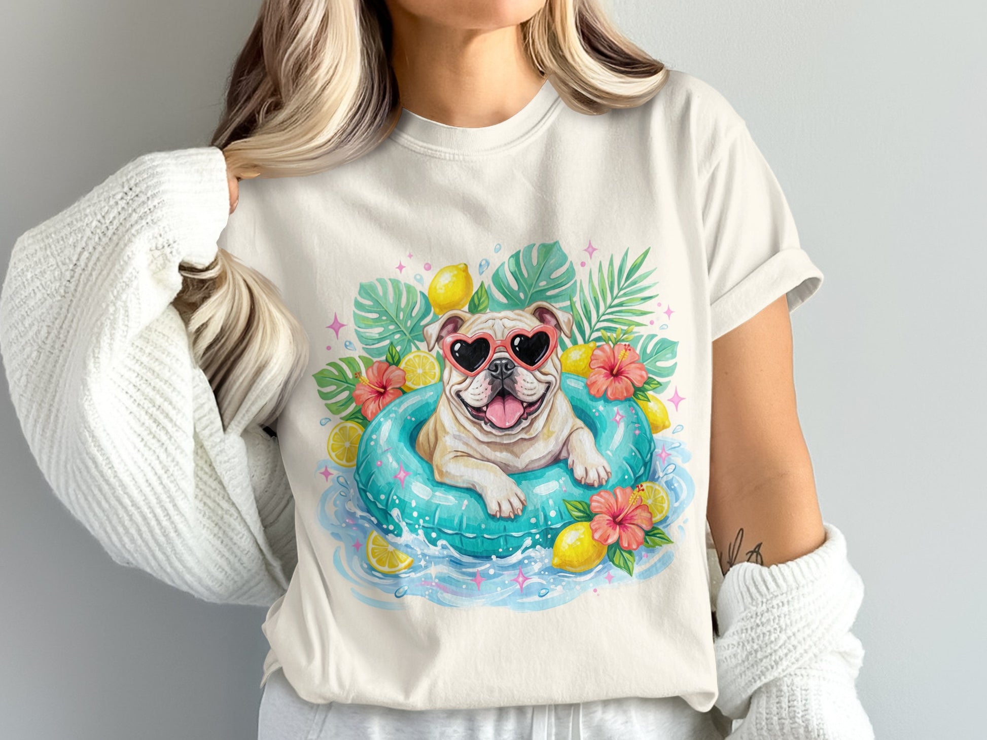 Bulldog in heart sunglasses floats in inner tube with lemons and tropical leaves.